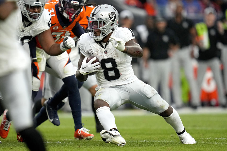 Las Vegas Raiders running back Josh Jacobs (8) runs the ball against the Denver Broncos during the second half of an NFL football game, Sunday, Sept. 10, 2023, in Denver. (AP Photo/Jack Dempsey)