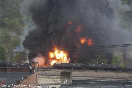 Flames and a large plume of black smoke are shown after a train derailment in this handout photo provided by the City of Lynchburg, Virginia April 30, 2014. REUTERS/City of Lynchburg, Virginia/Handout via Reuters
