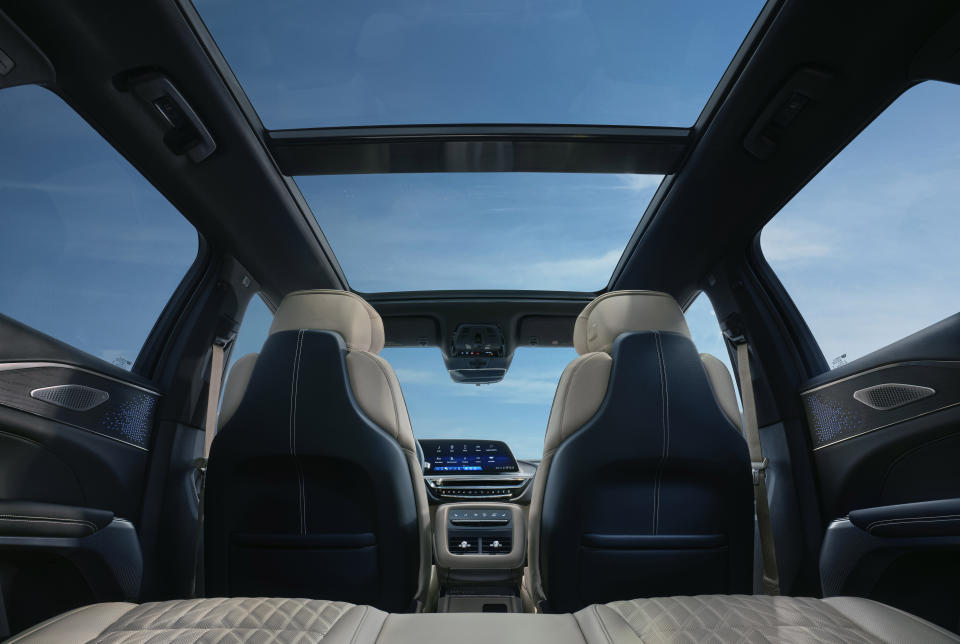 View of the 2025 Cadillac LYRIQ Luxury interior, looking up toward the panoramic power opening sunroof.