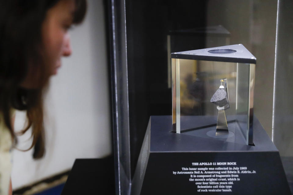 A moon rock is displayed within a glass case at the Armstrong Air & Space Museum, Wednesday, June 26, 2019, in Wapakoneta, Ohio. Neil Armstrong helped put Wapakoneta on the map July 20, 1969, when he became the first human to walk on the moon. The late astronaut remains larger than life in the city 60 miles (96.56 kilometers) north of Dayton, where visitors are greeted by the space base-shaped top of the space museum named for him as they exit Interstate 75. (AP Photo/John Minchillo)