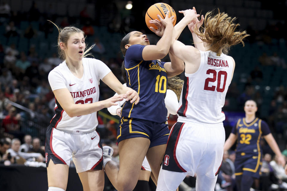 California guard Lulu Laditan-Twidale (10) grabs a rebound in between Stanford guards Hannah Jump (33) and Elena Bosgana (20) during the first half of an NCAA college basketball game in the quarterfinal round of the Pac-12 tournament Thursday, March 7, 2024, in Las Vegas. (AP Photo/Ian Maule)