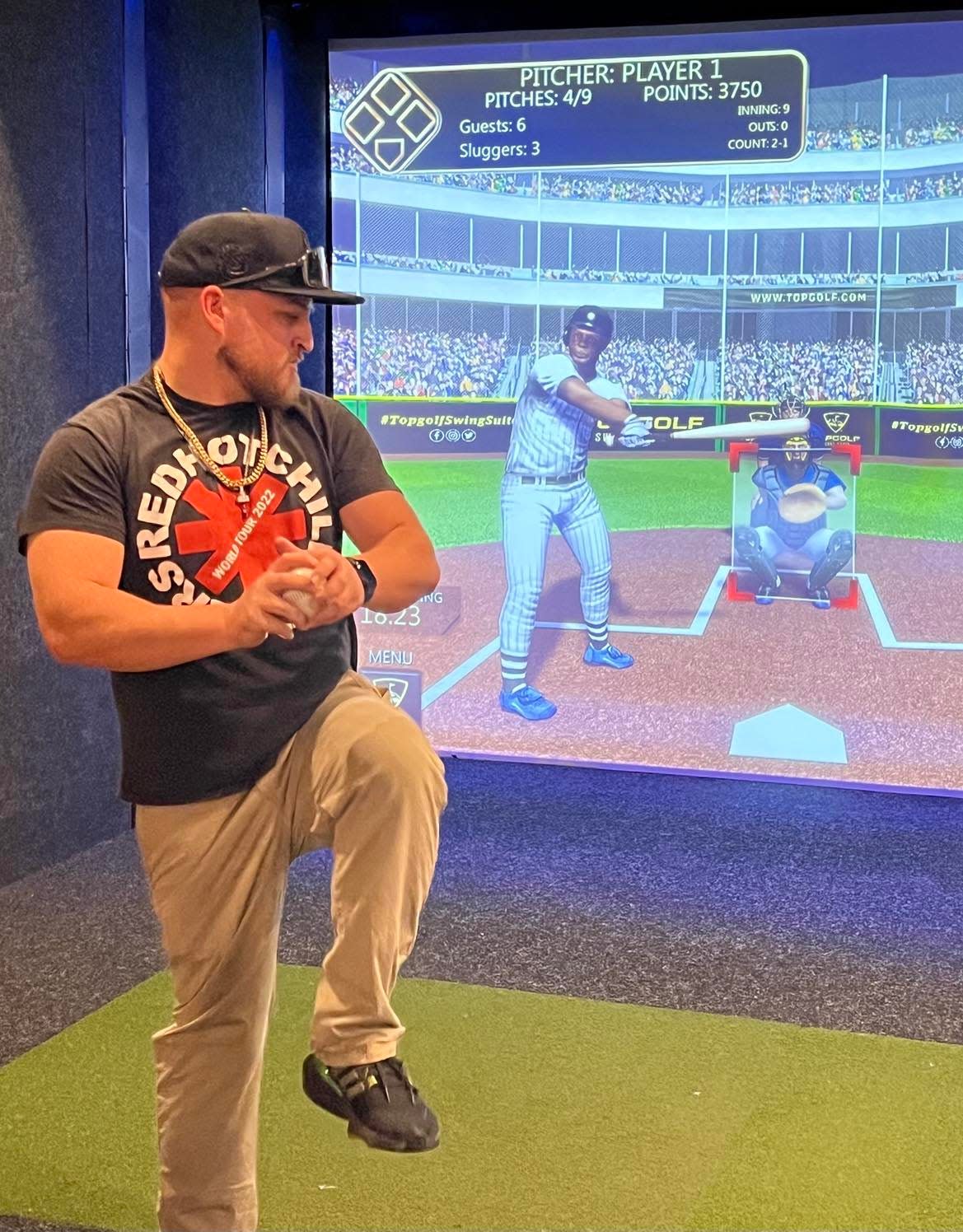 Dan Marrone, 29, readies to throw a baseball at a video screen at The Brew Kettle Topgolf Swing Suite at the Hall of Fame Village in Canton. Virtual golf and other sports games are featured at The Brew Kettle.