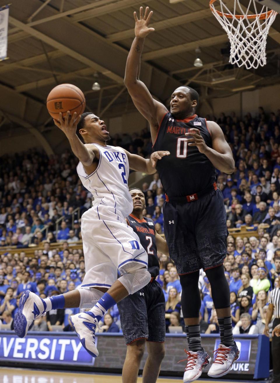 Duke's Quinn Cook (2) drives to the basket while Maryland's Charles Mitchell (0) defends during the first half of an NCAA college basketball game in Durham, N.C., Saturday, Feb. 15, 2014. (AP Photo/Gerry Broome)