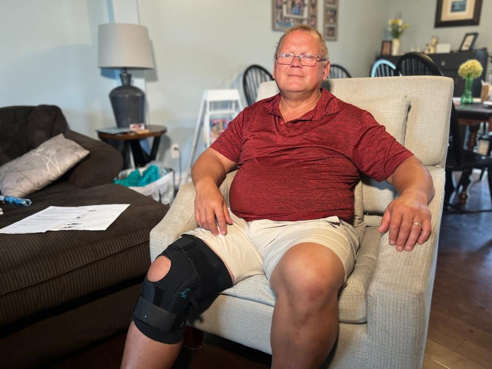 Edgar Arsenault says he wants to get back to things like walking and working, but can't until he gets his knee surgery.