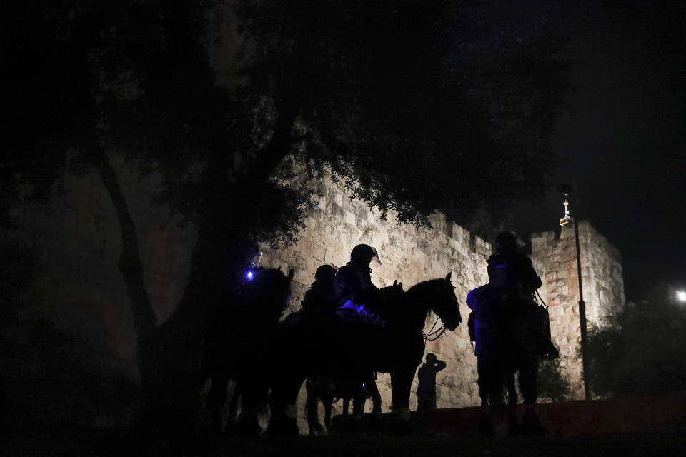 Israeli border police stand guard during clashes between Palestinians and Jewish extremist group "Lahava" just outside Jerusalem's Old City, Thursday, April 22, 2021. Members of the Jewish extremist group Lehava plan to march to the Damascus Gate in Jerusalem's Old City, where Palestinians have clashed with Israeli police in recent days over restrictions on outdoor gatherings during the holy month of Ramadan. Tensions are high in Jerusalem following a series of violent confrontations between Jewish and Palestinian youths who documented some of the assaults in TikTok videos. (AP Photo/Ariel Schalit)