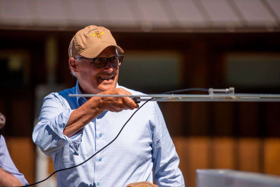 Washington Gov. Jay Inslee uses an antenna to track a transmitter during training for the capture of giant Asian hornets (Vespa mandarinia) held by the agriculture department at Birch Bay State Park on Tuesday morning July 12, in Blaine, Wash. The so-called “murder hornets” first appeared in the U.S. in Whatcom County during 2020.