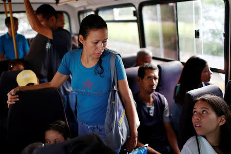 Anayanci Castillo (C), 37, talks to her daughter Katerine, while they travel on a bus before Anayanci's sterilization surgery in Ocumare, Venezuela July 26, 2016. REUTERS/Carlos Garcia Rawlins