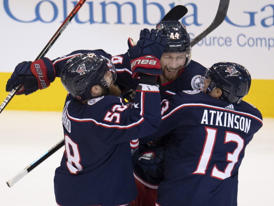 Columbus Blue Jackets defenseman Vladislav Gavrikov (44) is congratulated by teammates David Savard (58) and Cam Atkinson (13) after scoring on the Toronto Maple Leafs during the second period of an NHL hockey playoff game Friday, Aug. 7, 2020, in Toronto. (Frank Gunn/The Canadian Press via AP)