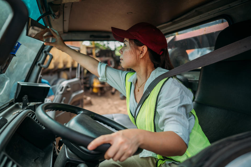 A woman driving a big truck