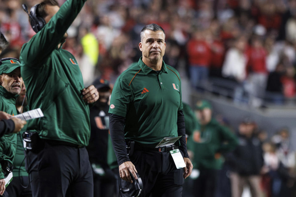 Miami head coach Mario Cristobal looks towards the scoreboard during the first half of an NCAA college football game against North Carolina State in Raleigh, N.C., Saturday, Nov. 4, 2023. (AP Photo/Ben McKeown)