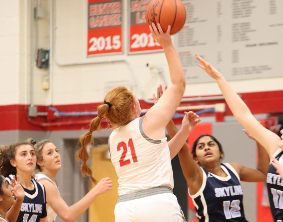 Aubrey Hensley of Bedford drives into the middle of the Ann Arbor Skyline defense during a 67-33 Bedford victory Tuesday night.