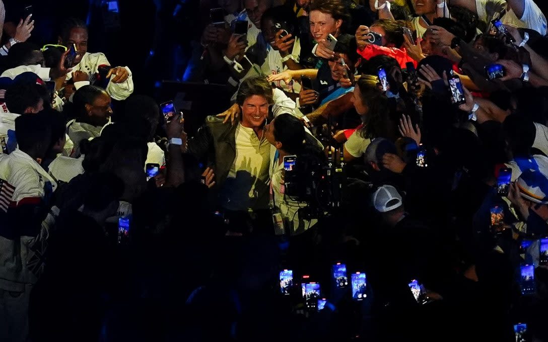 Tom Cruise surrounded by USA athletes during the closing ceremony of the 2024 Paris Olympic Games , at the Stade de France