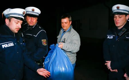 German police officers carry bags out of a house believed to belong to the parents of crashed Germanwings flight 4U 9524 co-pilot Andreas Lubitz in Montabaur, March 26, 2015. REUTERS/Ralph Orlowski