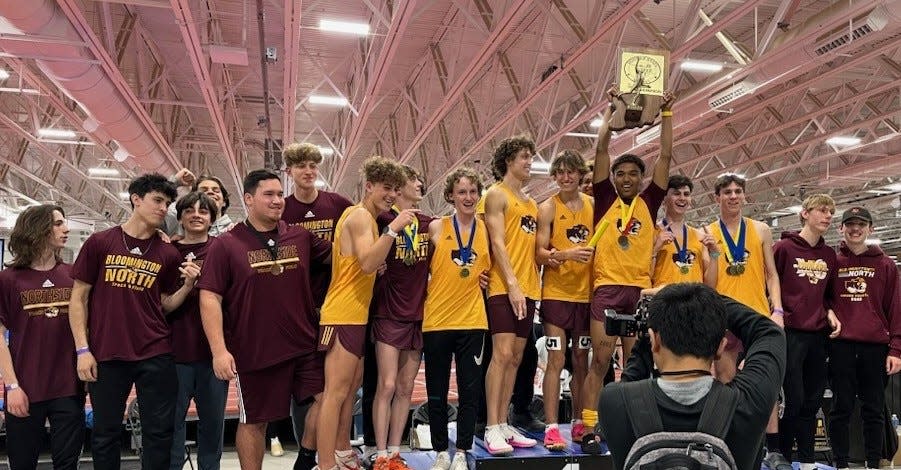 Members of the Bloomington North boys' track team pose on the podium with their first-place trophy at the end of the Hoosier State Relays at the Fall Creek Pavilion in Indianapolis on Saturday, March 23, 2024.