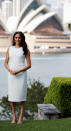 <p>While it looked like a rather unassuming ivory design, the frock by Australian designer Karen Gee is actually called the “Blessed Dress” – which is a feeling we’re sure rings true for the excited parents to be. Meghan paired the look with nude stiletto heels and wore her hair in perfect, duchess waves. Photo: AAP </p>