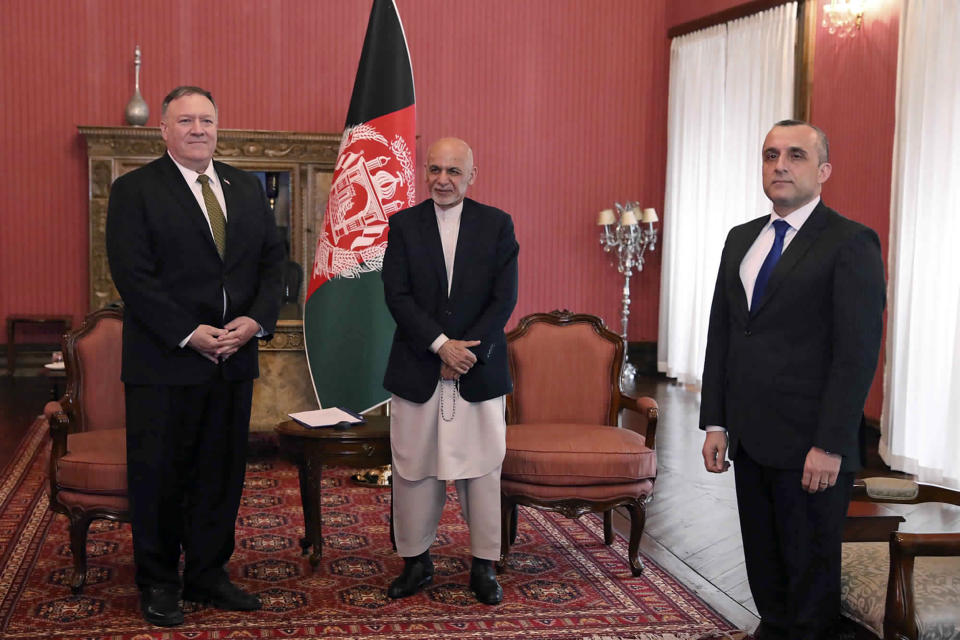 U.S. Secretary of State Mike Pompeo, left, stands with Afghan President Ashraf Ghani, center, and first Vice President Amrullah Saleh, at the Presidential Palace in Kabul, Afghanistan, Monday, March 23, 2020. Pompeo was in Kabul on an urgent visit Monday to try to move forward a U.S. peace deal signed last month with the Taliban, a trip that comes despite the coronavirus pandemic, at a time when world leaders and statesmen are curtailing official travel. (Afghan Presidential Palace via AP)