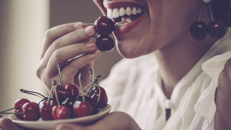 person eating cherries