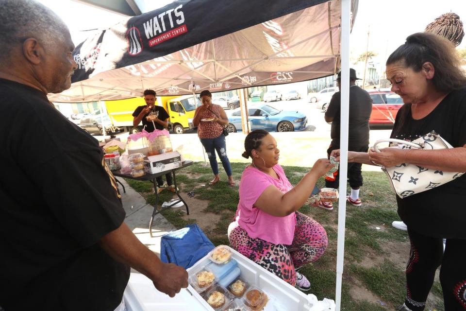 People sell cheesecake at a stand.