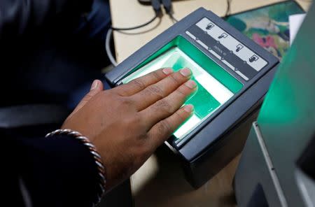 FILE PHOTO - A woman goes through the process of finger scanning for the Unique Identification (UID) database system, also known as Aadhaar, at a registration centre in New Delhi, India, January 17, 2018. Picture taken January 17, 2018. REUTERS/Saumya Khandelwal