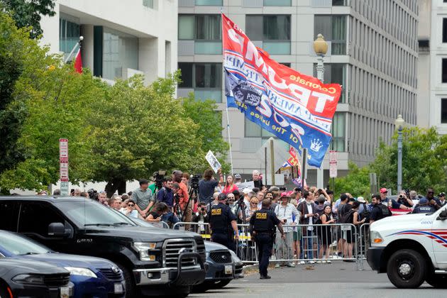 People look on after Trump arrives at the courthouse.