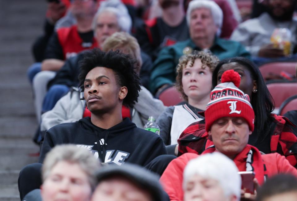 Former U of L basketball player Koron Davis, left, attended the men's game against Arkansas State at the Yum! Center in Louisville, Ky. on Dec. 13, 2023 after the university released a statement saying he has been dismissed from the team.