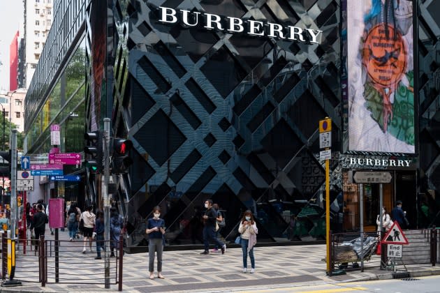 A pedestrian carries a Louis Vuitton shopping bag, from a store