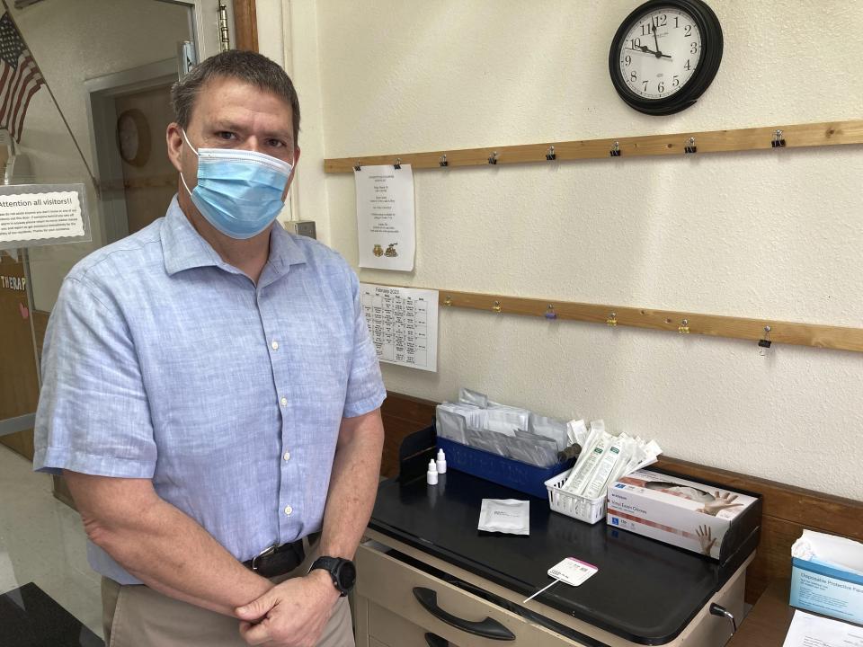 Tim Corbin, administrator of Truman Lake Manor, poses for a photo at the COVID-19 testing station in the nursing home's entryway on Tuesday, Feb. 14, 2023, in Lowry, Mo. Employees and visitors must pass a COVID-19 test each day they enter the facility. Despite that precaution, the nursing home still had COVID-19 outbreak late last year that affected employees and residents. (AP Photo/David A. Lieb)