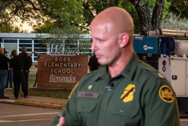 A Customs and Border Patrol agent speaks to a reporter near the scene of a school shooting on Tuesday, May 24, 2022 in Uvalde, Texas. (Sergio Flores for The Texas Tribune)