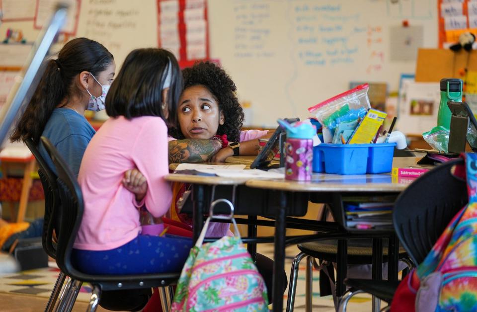 Second-grade teacher Sarah Dilworth reviews a lesson plan last fall with two students at Joslin Elementary School in South Austin. A poll last year found three-quarters of Texas teachers were seriously considering leaving the profession.