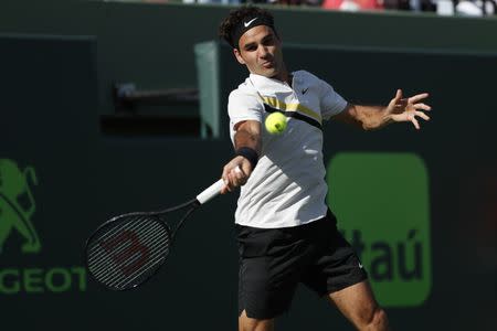 Mar 24, 2018; Key Biscayne, FL, USA; Roger Federer of Switzerland hits a forehand against Thanasi Kokkinakis of Australia (not pictured) on day five of the Miami Open at Tennis Center at Crandon Park. Kokkinakis won 3-6, 6-3, 7-6(4). Mandatory Credit: Geoff Burke-USA TODAY Sports