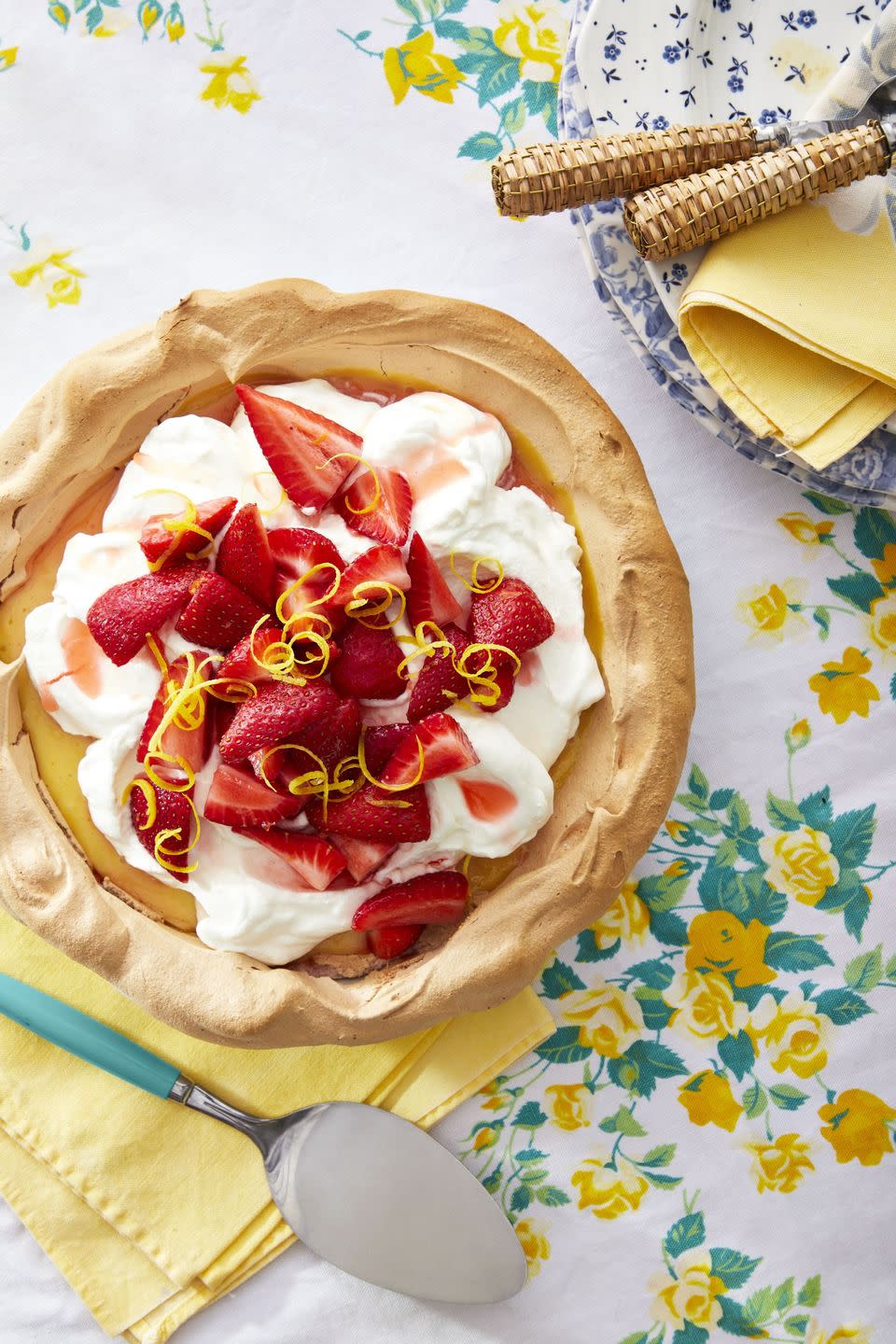 strawberry lemonade angel pie in a meringue crust and topped with whipped cream fresh strawberries and lemon zest