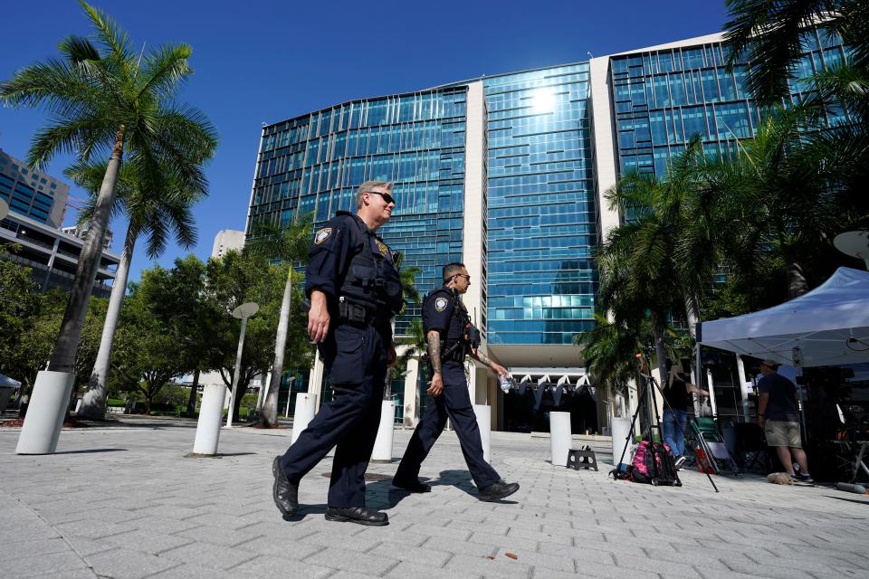 Federal Protective Service Police walk along the sidewalk outside the Wilkie D. Ferguson Jr. U.S. Courthouse, Monday, June 12, 2023, in Miami. Former President Donald Trump is set to appear at the federal court Tuesday.