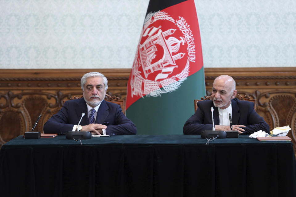 Afghan President Ashraf Ghani, right, and political rival Abdullah Abdullah, speak after they signed a power-sharing agreement at the presidential palace in Kabul, Afghanistan, Sunday, May 17, 2020. Ghani and Abdullah signed the power-sharing agreement eight months after both declared themselves the winner of last September's presidential election. Sediq Sediqqi tweeted Sunday that a political deal between Ghani and Abdullah had been signed in which Ghani would remain president of the war-torn nation and Abdullah would lead the country's National Reconciliation High Council. (Afghan Presidential Palace via AP)