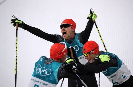 Nordic Combined Events - Pyeongchang 2018 Winter Olympics - Men's Individual 10 km Final - Alpensia Cross-Country Skiing Centre - Pyeongchang, South Korea - February 20, 2018 - Johannes Rydzek of Germany, Fabian Riessle of Germany and Eric Frenzel of Germany celebrate. REUTERS/Carlos Barria