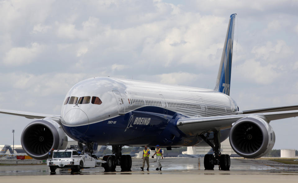 FILE - Boeing employees walk the new Boeing 787-10 Dreamliner down towards the delivery ramp area at the company's facility after conducting its first test flight at Charleston International Airport, March 31, 2017, in North Charleston, S.C. Boeing will be in the spotlight during back-to-back hearings Wednesday, April 17, 2024, as Congress examines allegations of major safety failures at the embattled aircraft manufacturer. (AP Photo/Mic Smith, File)