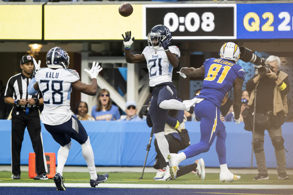 Tennessee Titans cornerback Roger McCreary (21) tosses the ball to safety Joshua Kalu (28) to intercept a pass intended to Los Angeles Chargers wide receiver Mike Williams (81) on Dec. 18, 2022, in Inglewood, Calif. (AP Photo/Kyusung Gong)