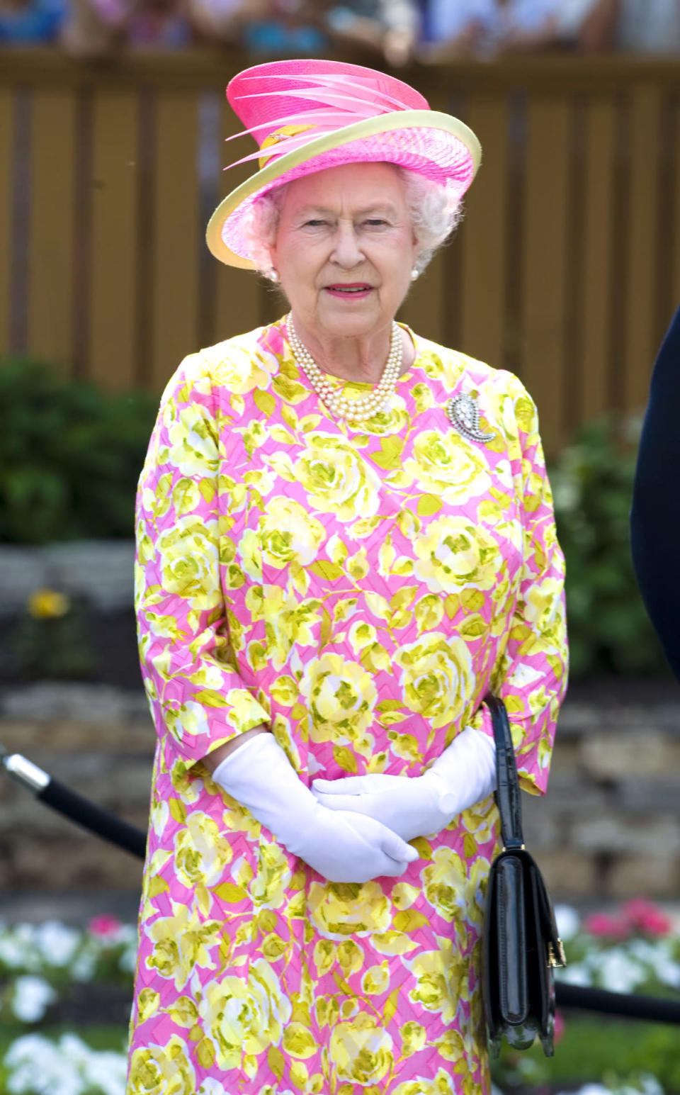 <p>At a lunch in Canada, the Queen donned an eye-catching pink dress covered with yellow flowers. <i>[Photo: Rex]</i></p>