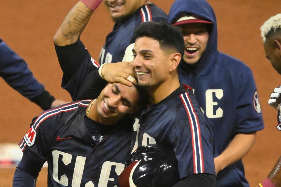 Guardians shortstop Brayan Rocchio (left) celebrates his game-winning RBI single with second baseman Andres Gimenez (center) and Steven Kwan (wearing hoodie) in the 10th inning against the Twins, Sept. 18, 2024, in Cleveland.