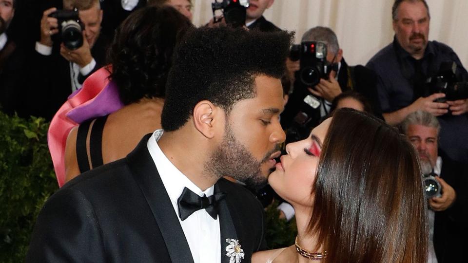 The Weeknd kisses Selena Gomez at the 2017 Costume Institute Benefit at Metropolitan Museum of Art on May 1, 2017 in New York City.