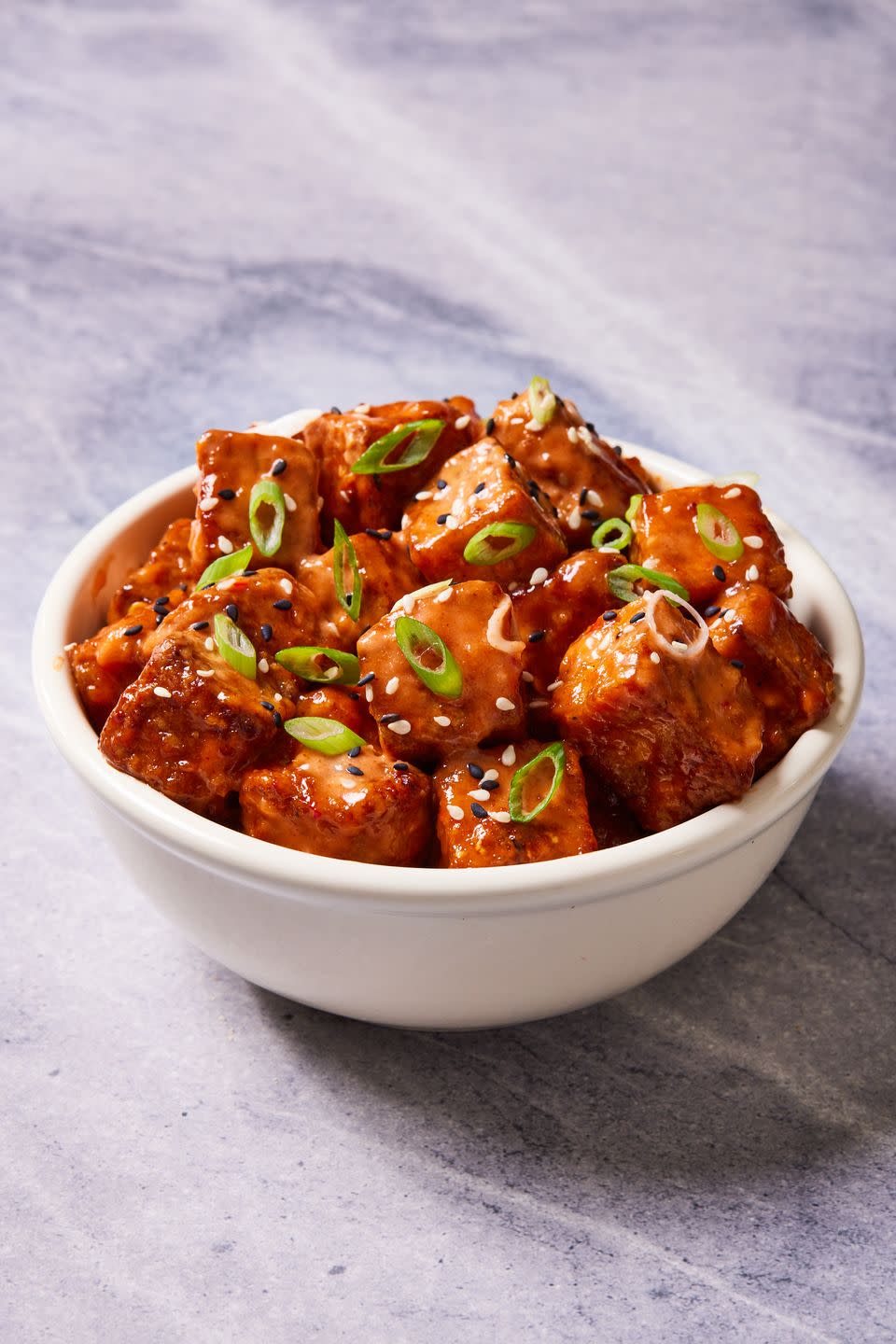 <p>The basic steps of this recipe are to marinate the <a href="https://www.delish.com/cooking/g26001696/tofu-recipes/" rel="nofollow noopener" target="_blank" data-ylk="slk:tofu;elm:context_link;itc:0;sec:content-canvas" class="link ">tofu</a>, dredge it in cornstarch, air fry it, and then toss it with sauce. The marinade and sauce is entirely up to you, but we happen to love this soy marinade and spicy sauce combo, which reminds us a lot of <a href="https://www.delish.com/cooking/recipe-ideas/recipes/a53694/bang-bang-shrimp-recipe/" rel="nofollow noopener" target="_blank" data-ylk="slk:bang bang shrimp;elm:context_link;itc:0;sec:content-canvas" class="link ">bang bang shrimp</a>!</p><p>Get the <strong><a href="https://www.delish.com/cooking/recipe-ideas/a37826062/air-fryer-tofu-recipe/" rel="nofollow noopener" target="_blank" data-ylk="slk:Air Fryer Tofu recipe;elm:context_link;itc:0;sec:content-canvas" class="link ">Air Fryer Tofu recipe</a>.</strong></p>