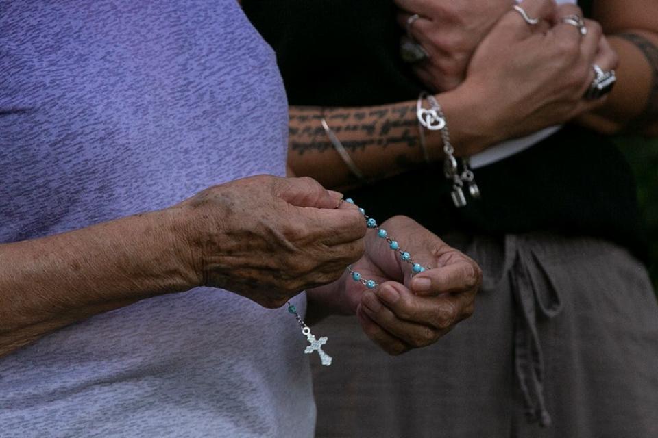 The rosary is said in Spanish as family and friends mourn the loss of 39-year-old Christina Michelle Limon and her son, 14-year-old Rudy Xavier Limon-Lirra during the memorial service in the east Austin Garden View Drive neighborhood on Friday, April 29, 2022. 