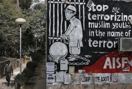 A man walks past graffiti inside the Jawaharlal Nehru University (JNU) campus in New Delhi, India, February 15, 2016. REUTERS/Anindito Mukherjee