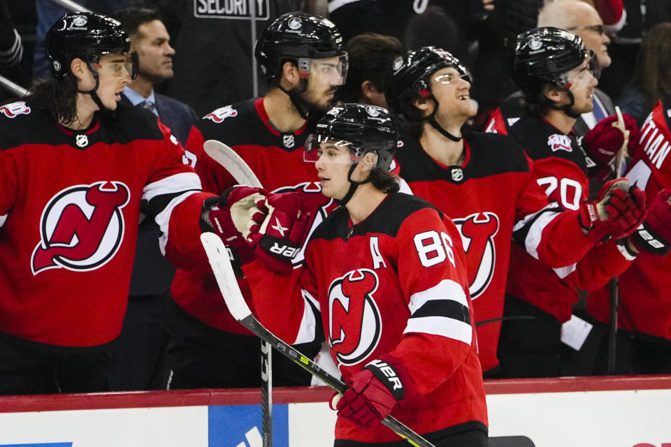 New Jersey Devils' Jack Hughes (86) celebrates with teammates after scoring a goal during the first period of an NHL hockey game against the Pittsburgh Penguins, Sunday, Jan. 22, 2023, in Newark, N.J. (AP Photo/Frank Franklin II)