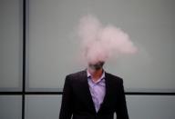 A man vapes outside Southwark Crown Court in London, Britain, September 25, 2017. REUTERS/Hannah McKay