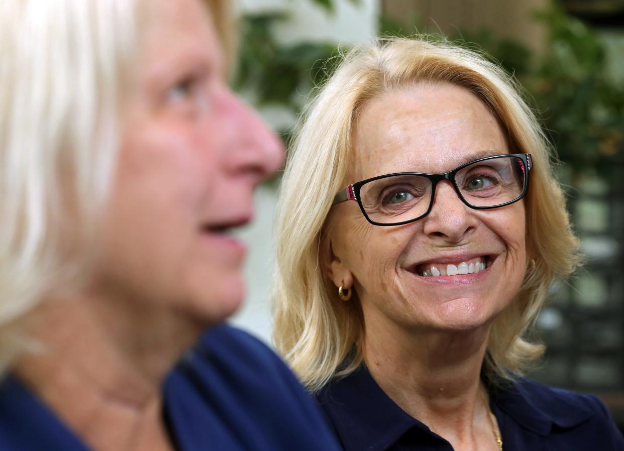 Lynn Wagner, right, is all smiles as she listens to her sister-in-law, Rebecca Wert, her brother James Wert's widow Rebecca recall fond memories during an interview Wednesday, July 17, 2024, at Ravenna Police Department. Patrolman James Wert will have a section of State Route 88 named in his honor. Wert was killed by a drunken driver in 1981 during a traffic stop.