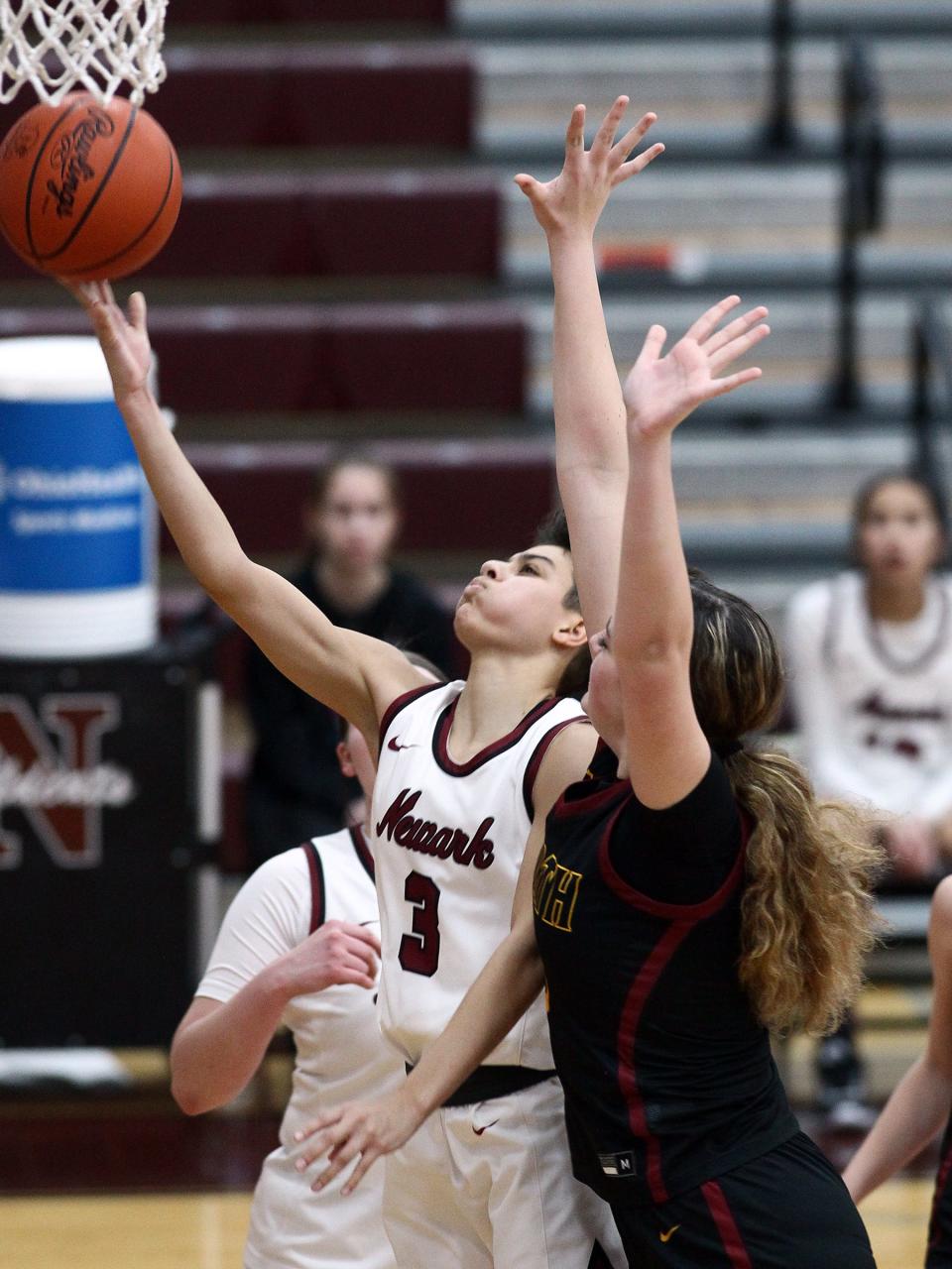 Newark senior Brie Gingras shoots a layup under pressure from Westerville North's Chloe Shockley on Tuesday, Dec. 20, 2022 at Jimmy Allen Gymnasium. The host Wildcats fell 56-49.