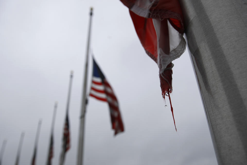 FILE - In this May 22, 2020, file photo, a raindrop falls from an American flag at half-staff at the Washington Monument, in Washington. President Donald Trump ordered American flags to be flown at half-staff for a three day period in remembrance of Americans who have lost their lives due to the coronavirus outbreak. (AP Photo/Patrick Semansky, File)