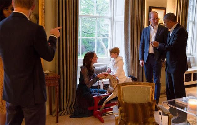 George plays on his rocking horse.