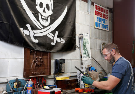 FILE PHOTO: Rodger Brown finishes work on a front sight post assembly for an AR-15 style rifle barrel at Spike's Tactical LLC, a gunmaker in Apopka, Florida, U.S. December 10, 2018. REUTERS/Gregg Newton