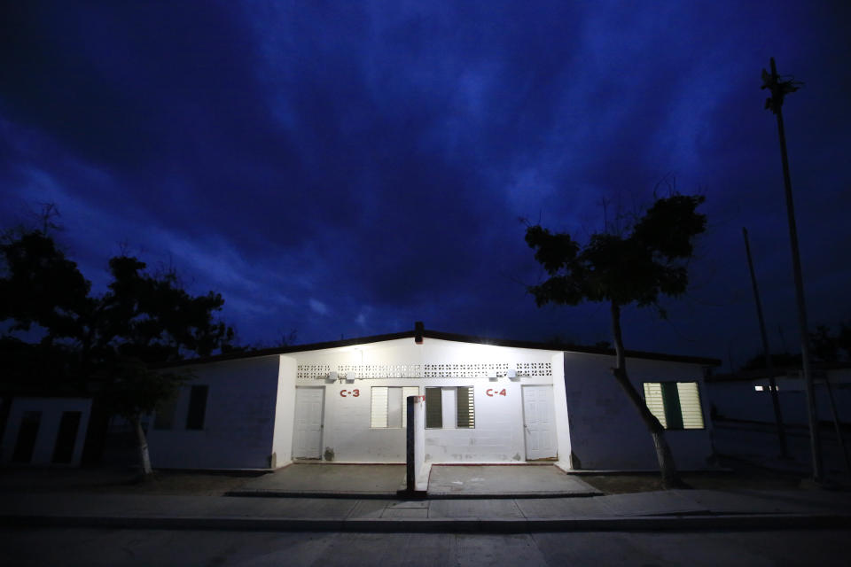 Numbers and letters mark bungalows, each of which housed 14-prisoners in bunk-bed dormitories with a shared, open bathroom, at the now closed Morelos detention center during a media tour of the former Islas Marias penal colony located off Mexico's Pacific coast, at dawn Saturday, March 16, 2019. The "semi-freedom" the island offered to inmates suffered under the influx of prisoners when in 2016 the colony was turned into a regular prison, triggering the overcrowded, under-fed inmates to riot in 2013, killing six people before marines regained control of the island. (AP Photo/Rebecca Blackwell)